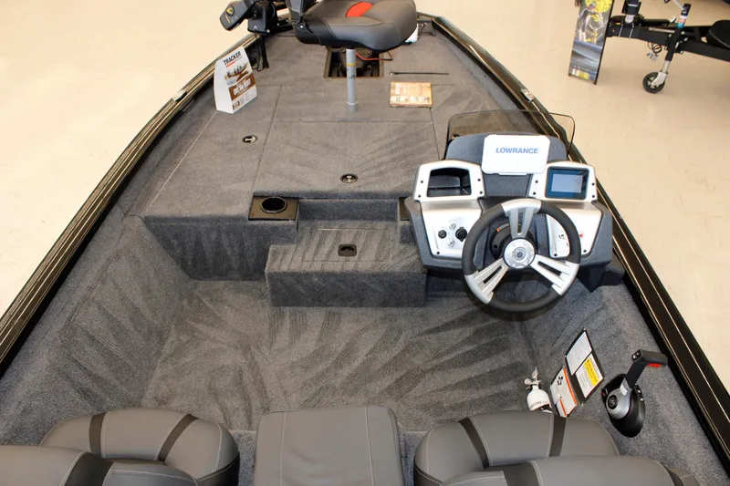 Slide: The Image of 2026 Tracker Pro Team 175 boat interior with steering wheel and navigation system. - 7