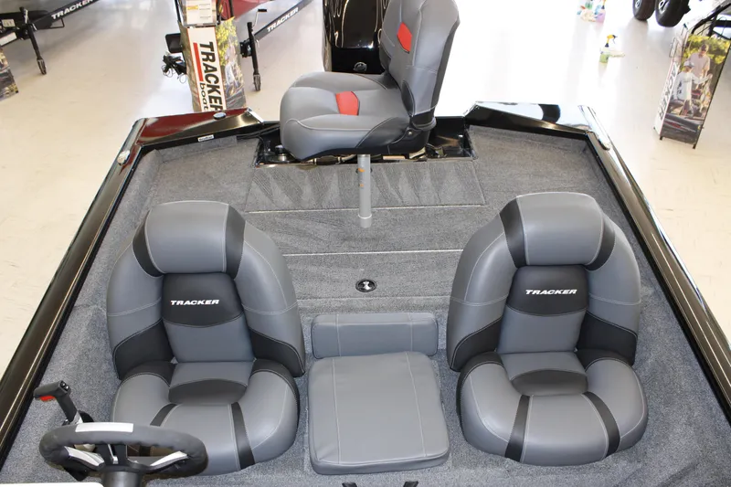 Slide: The Image of 2026 Tracker Pro Team 175 boat interior with gray seating and steering wheel. - 5