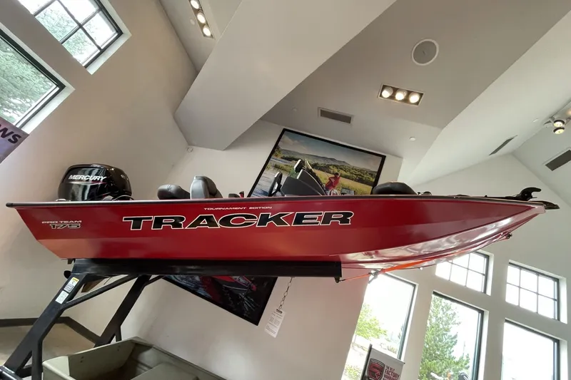 The Image of 2026 Tracker Pro Team 175 boat displayed indoors, featuring a sleek red design. - 0
