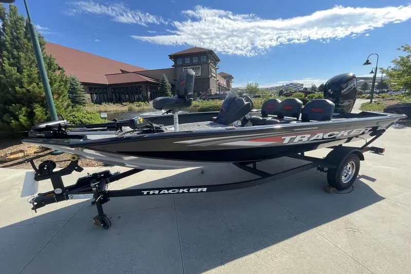 The Image of 2026 Tracker Pro Team 175 boat on trailer, parked outdoors under clear sky. - 0