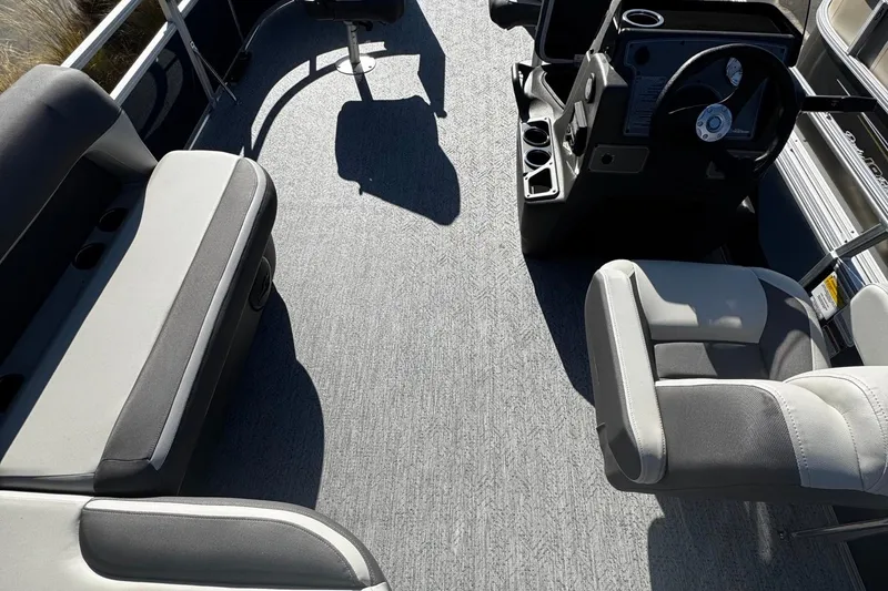 Slide: The Image of Interior view of 2026 Sun Tracker Bass Buggy 16 XL Select pontoon boat with seating and steering console. - 3