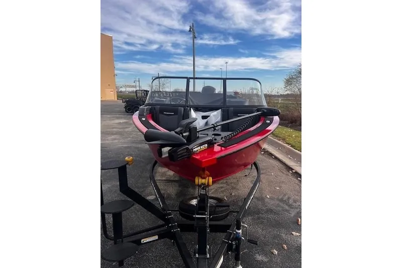 Slide: The Image of 2026 Tracker Targa V-18 WT boat on trailer, parked outdoors under blue sky. - 83