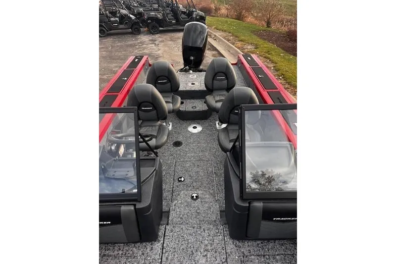 Slide: The Image of 2026 Tracker Targa V-18 WT boat interior with seating and windshield, parked outdoors. - 86