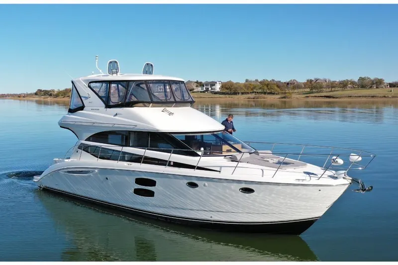 The Image of 2016 Meridian 441 yacht cruising on calm waters under clear blue skies. - 0