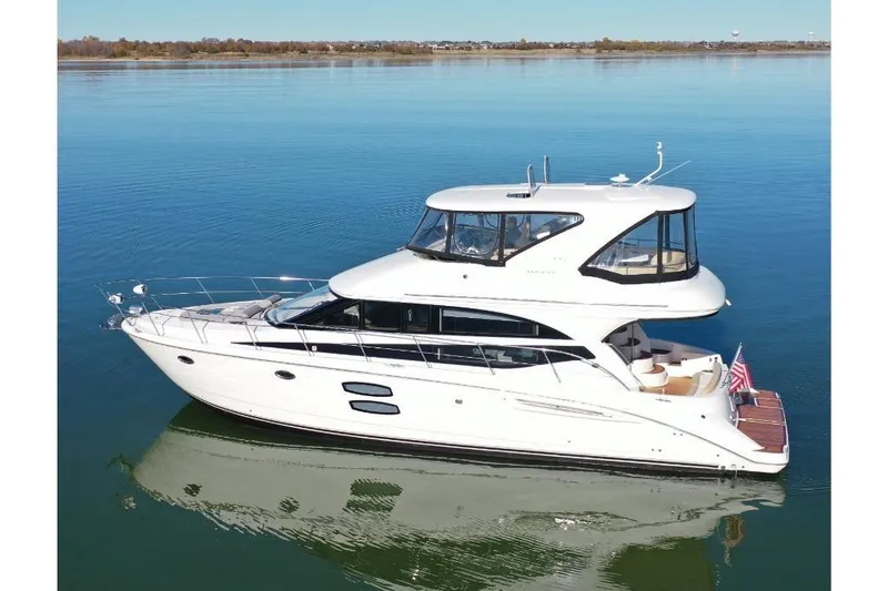Slide: The Image of 2016 Meridian 441 yacht on calm water, showcasing sleek design and luxury features. - 10