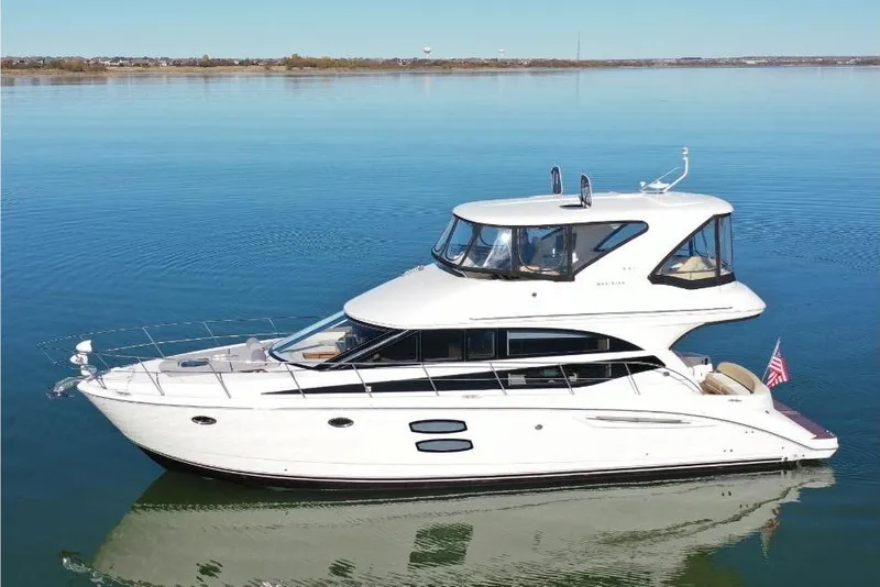Slide: The Image of 2016 Meridian 441 yacht on calm water, side view, clear sky background. - 11