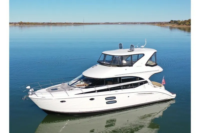 Slide: The Image of 2016 Meridian 441 yacht cruising on calm waters under clear blue skies. - 12
