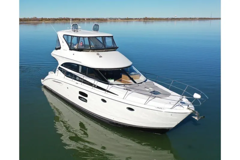 Slide: The Image of 2016 Meridian 441 yacht cruising on calm waters. - 15
