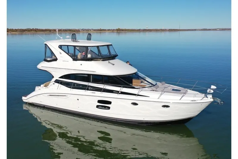 Slide: The Image of 2016 Meridian 441 yacht cruising on calm waters under clear skies. - 16