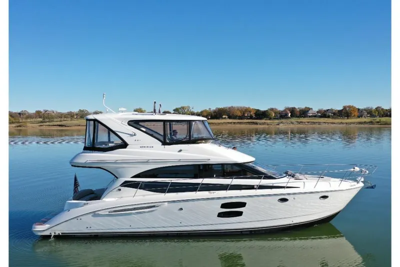 Slide: The Image of 2016 Meridian 441 yacht on calm water under clear blue sky. - 17
