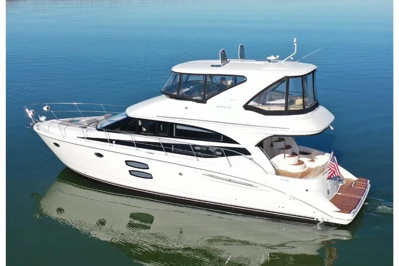 Slide: The Image of 2016 Meridian 441 yacht cruising on calm blue waters. - 19