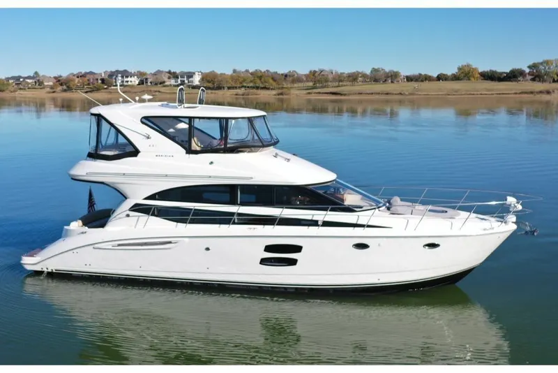 Slide: The Image of 2016 Meridian 441 yacht on calm water, showcasing sleek design and luxury features. - 2