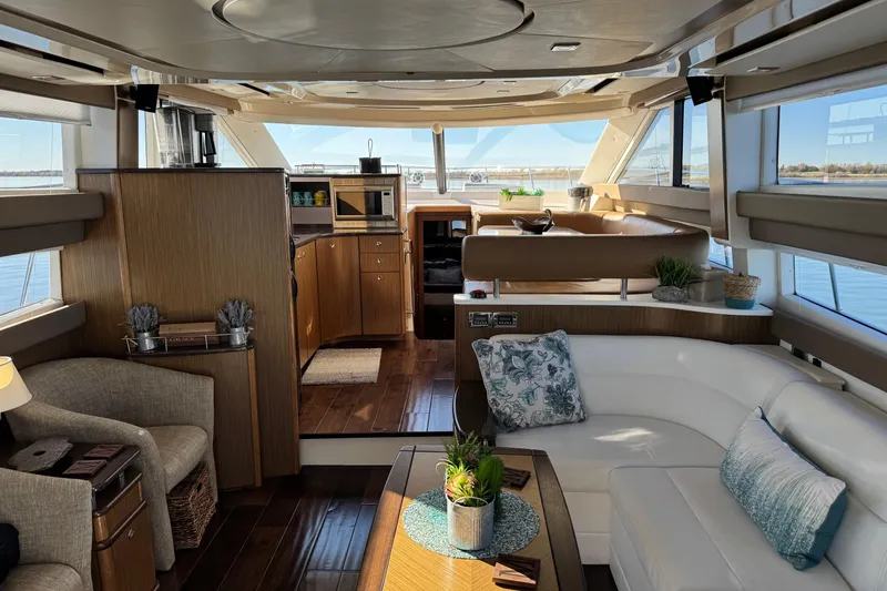 Slide: The Image of Luxurious interior of a 2016 Meridian 441 yacht with modern furnishings and panoramic windows. - 22