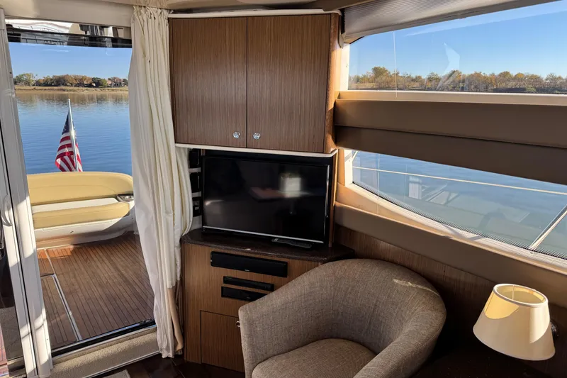 Slide: The Image of Interior of 2016 Meridian 441 yacht with TV, chair, and lake view. - 25
