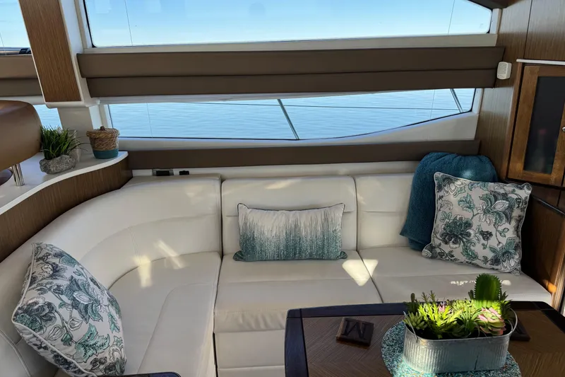 Slide: The Image of Luxurious 2016 Meridian 441 yacht interior with elegant white seating and decorative cushions. - 28