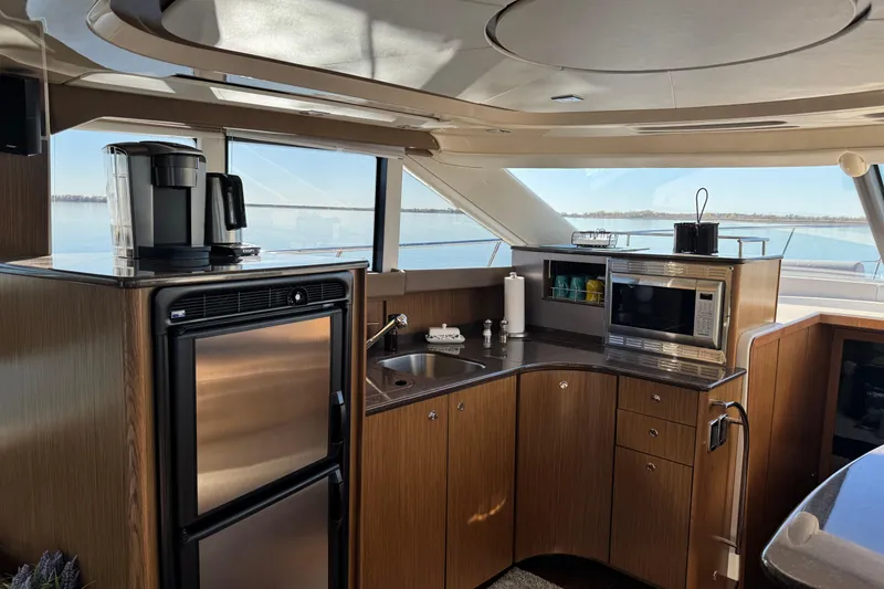 Slide: The Image of Luxurious 2016 Meridian 441 yacht kitchen with modern appliances and scenic water views. - 32