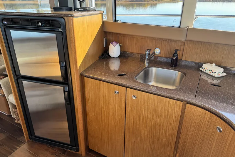 Slide: The Image of Modern kitchen area in a 2016 Meridian 441 yacht with sink and refrigerator. - 33