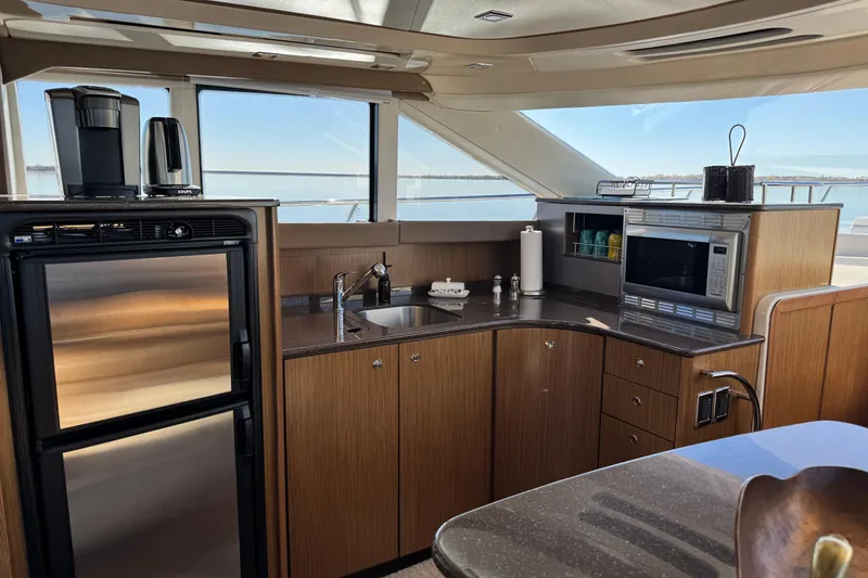 Slide: The Image of Luxurious 2016 Meridian 441 yacht kitchen with modern appliances and sleek wood cabinetry. - 35