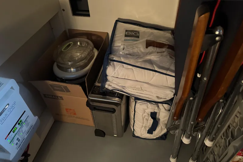 Slide: The Image of Storage area in a 2016 Meridian 441 with packed items and folded chairs. - 42