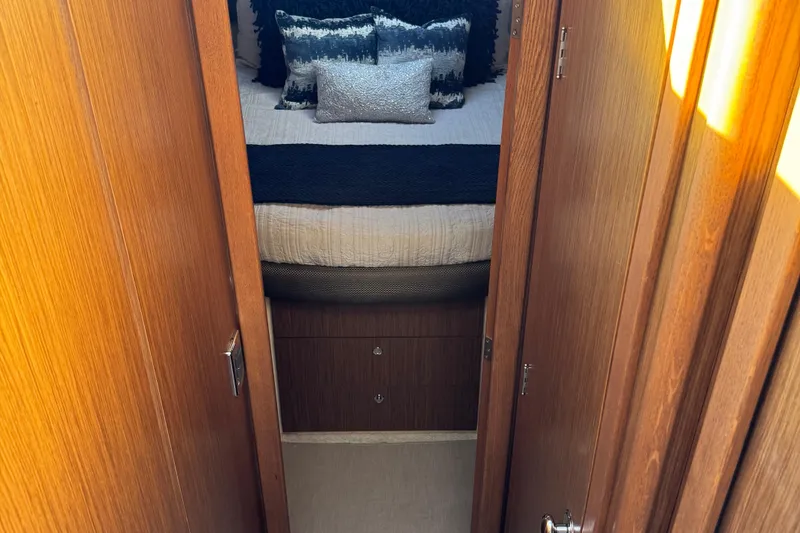 Slide: The Image of Cozy bedroom in 2016 Meridian 441 yacht with elegant bedding and wooden doors. - 44