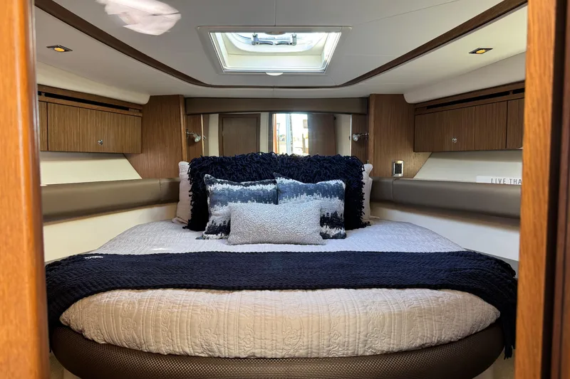 Slide: The Image of Luxurious 2016 Meridian 441 yacht bedroom with elegant bedding and wood accents. - 46