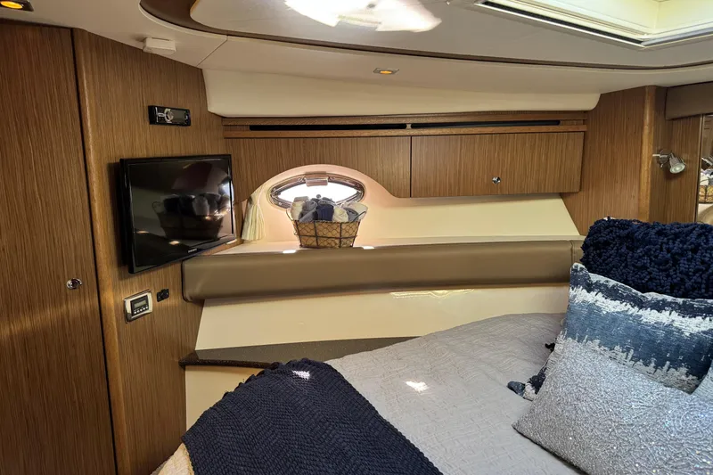 Slide: The Image of Luxurious interior of a 2016 Meridian 441 yacht with cozy bedding and a mounted TV. - 48