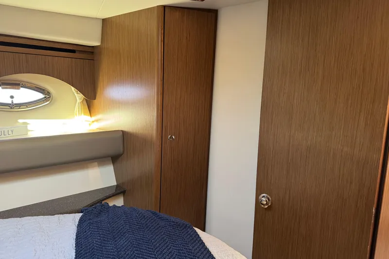 Slide: The Image of Interior of 2016 Meridian 441 yacht cabin with wood paneling and porthole window. - 53