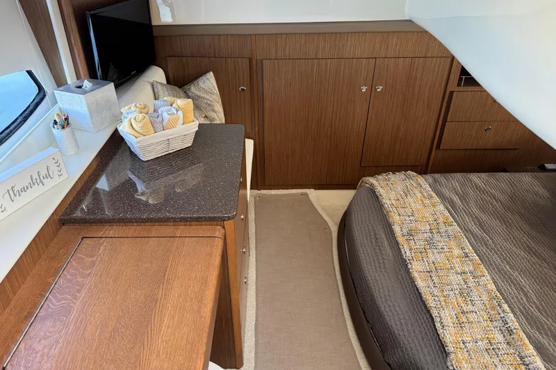 Slide: The Image of Luxurious 2016 Meridian 441 yacht interior with elegant wood cabinetry and cozy bedding. - 56