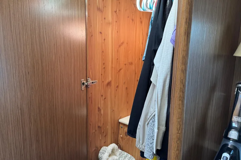 Slide: The Image of Wooden closet interior with hanging clothes in a 2016 Meridian 441. - 60