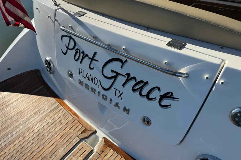 Slide: The Image of 2016 Meridian 441 yacht named "Port Grace" in Plano, TX, with American flag. - 64