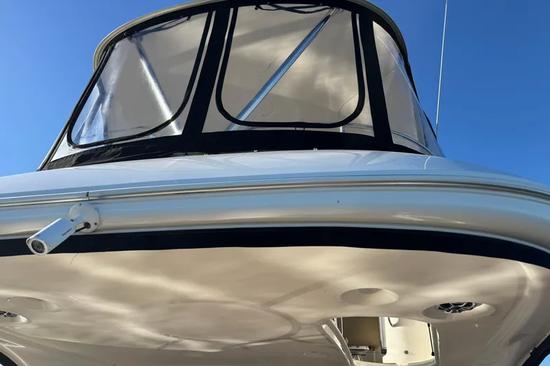 Slide: The Image of 2016 Meridian 441 yacht with enclosed flybridge, viewed from below against blue sky. - 68