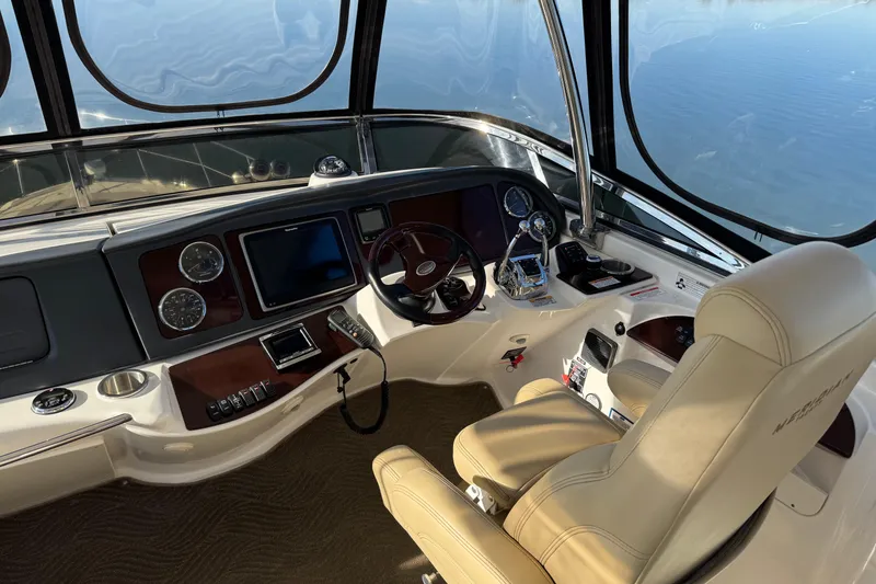Slide: The Image of 2016 Meridian 441 yacht helm with modern controls and panoramic windows. - 69