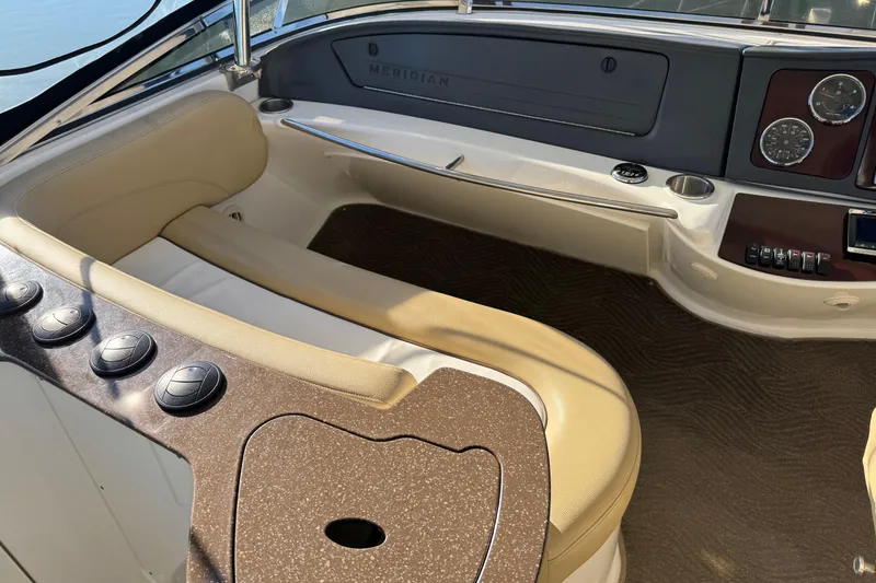 Slide: The Image of Interior of a 2016 Meridian 441 yacht with beige seating and control panel. - 74