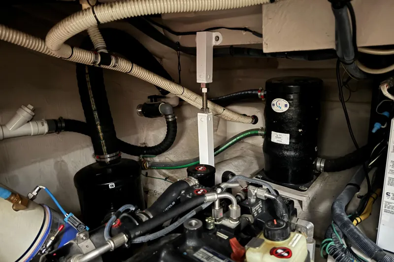 Slide: The Image of Engine room of a 2016 Meridian 441 yacht with visible pipes and machinery. - 88