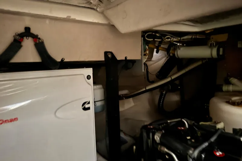 Slide: The Image of Engine room of a 2016 Meridian 441 yacht, featuring mechanical components and wiring. - 89