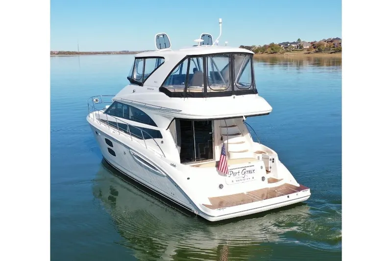 Slide: The Image of Luxury 2016 Meridian 441 yacht cruising on calm waters, rear view. - 9