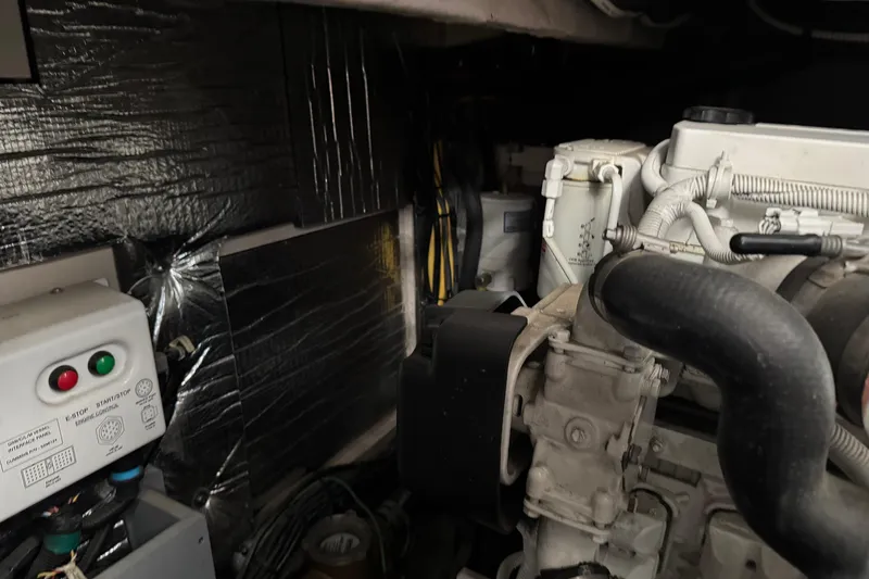 Slide: The Image of Engine room of a 2016 Meridian 441 yacht, showcasing mechanical components and wiring. - 90