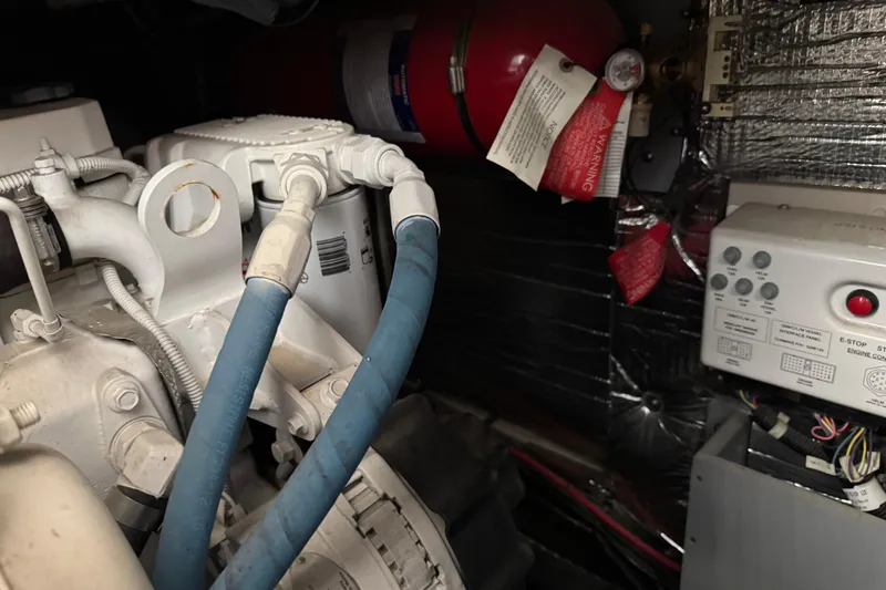 Slide: The Image of Engine room of a 2016 Meridian 441 with hoses and control panel. - 93