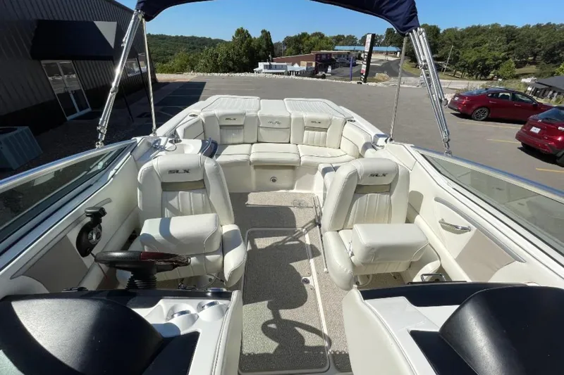 Slide: The Image of 2007 Sea Ray 250 SLX boat interior with white seating and steering wheel. - 10