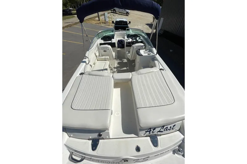 Slide: The Image of 2007 Sea Ray 250 SLX boat interior with white seating and blue canopy. - 13