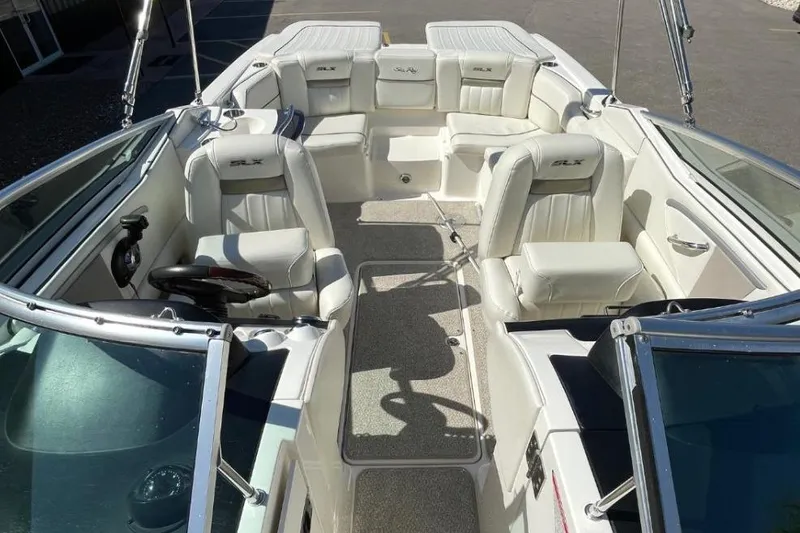Slide: The Image of 2007 Sea Ray 250 SLX boat interior with white leather seating and steering wheel. - 3