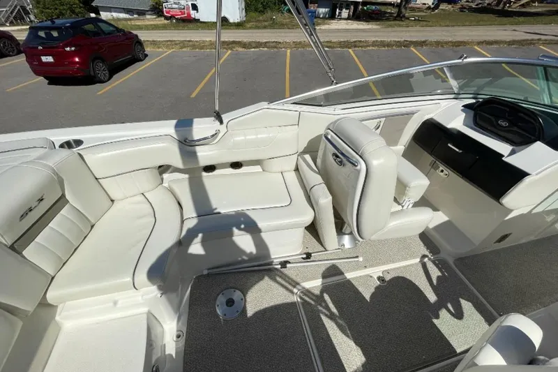 Slide: The Image of 2007 Sea Ray 250 SLX boat interior with white leather seating and steering console. - 5