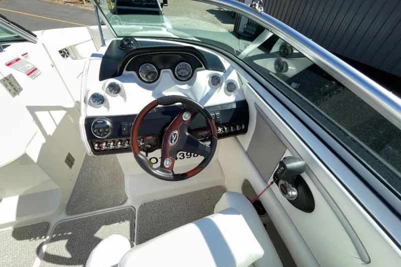 Slide: The Image of 2007 Sea Ray 250 SLX boat cockpit with steering wheel and control panel. - 6