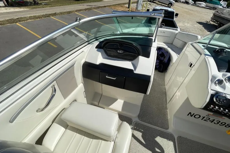 Slide: The Image of 2007 Sea Ray 250 SLX boat interior with white seating and dashboard view. - 7
