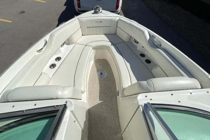 Slide: The Image of 2007 Sea Ray 250 SLX boat interior with white seating and cup holders. - 8