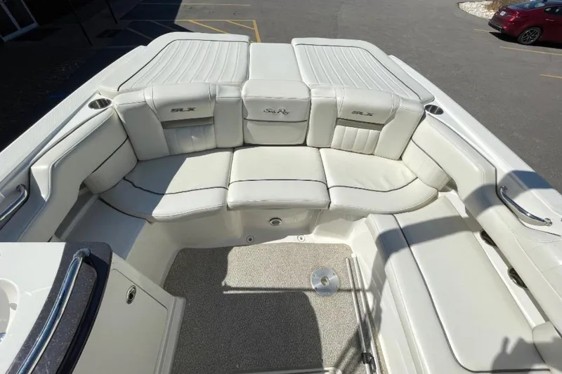 Slide: The Image of 2007 Sea Ray 250 SLX boat interior with white leather seating and carpeted floor. - 9