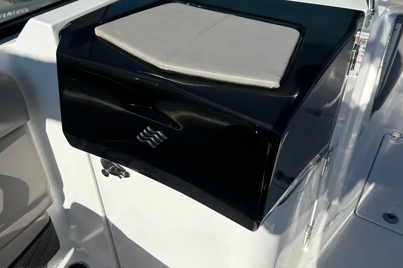 Slide: The Image of 2022 Four Winns HD5 OB boat interior detail with sleek black and white design. - 13