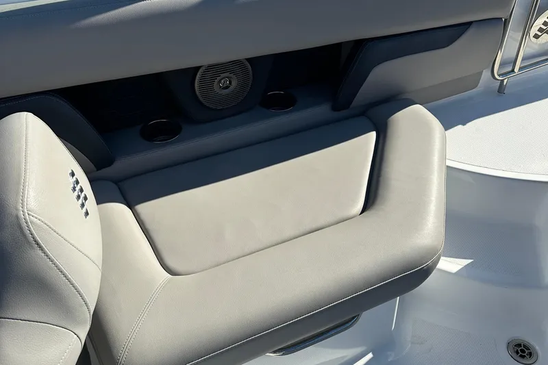 Slide: The Image of 2022 Four Winns HD5 OB boat interior seating with speaker and cup holders. - 17