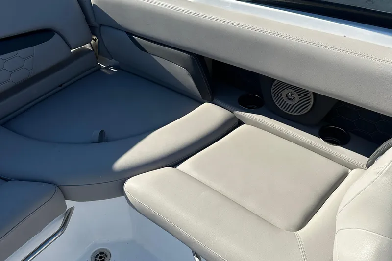 Slide: The Image of 2022 Four Winns HD5 OB boat interior with gray seating and built-in speaker. - 21
