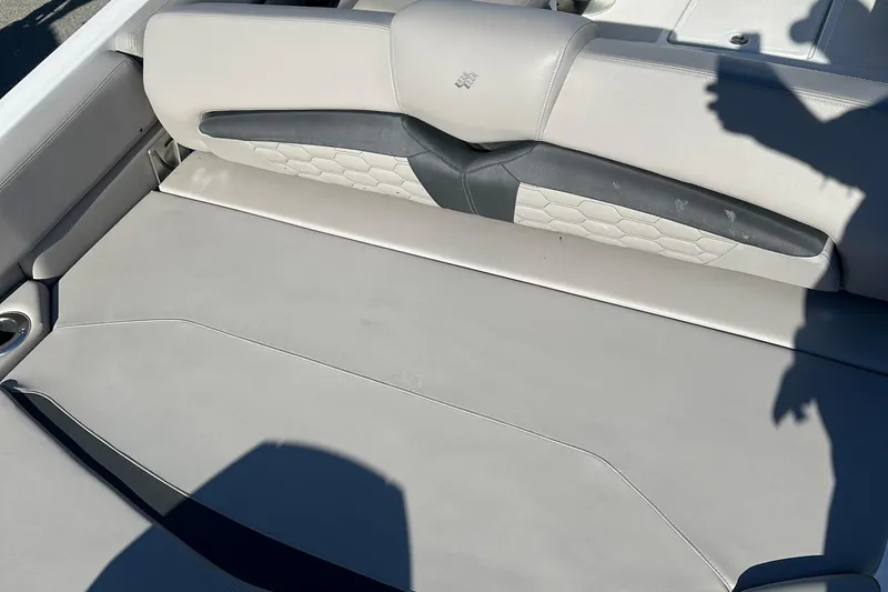 Slide: The Image of 2022 Four Winns HD5 OB boat interior seating with gray upholstery and cup holder. - 22